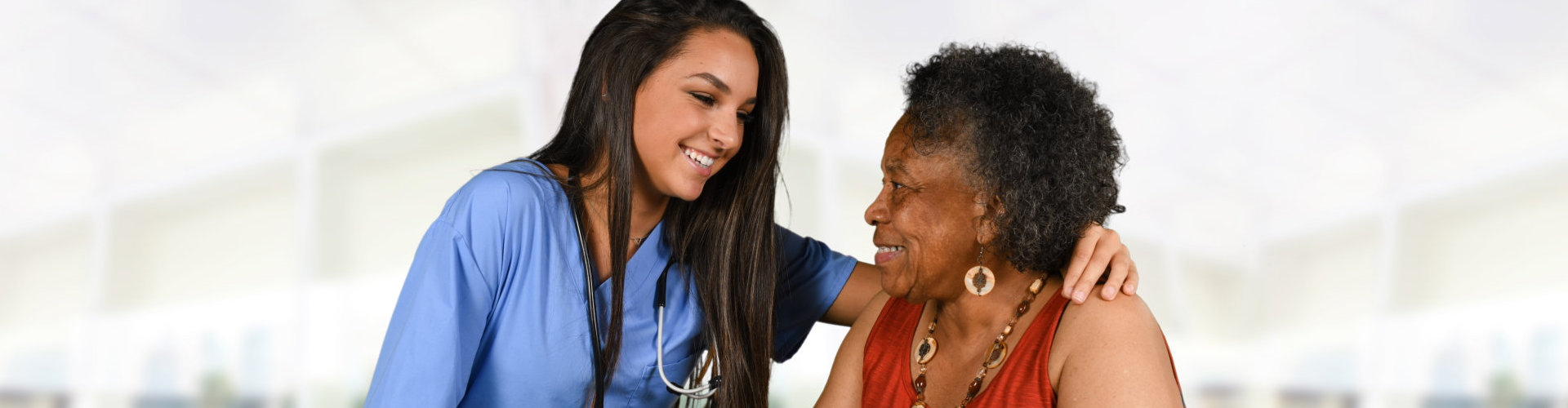 senior woman with her nurse smiling